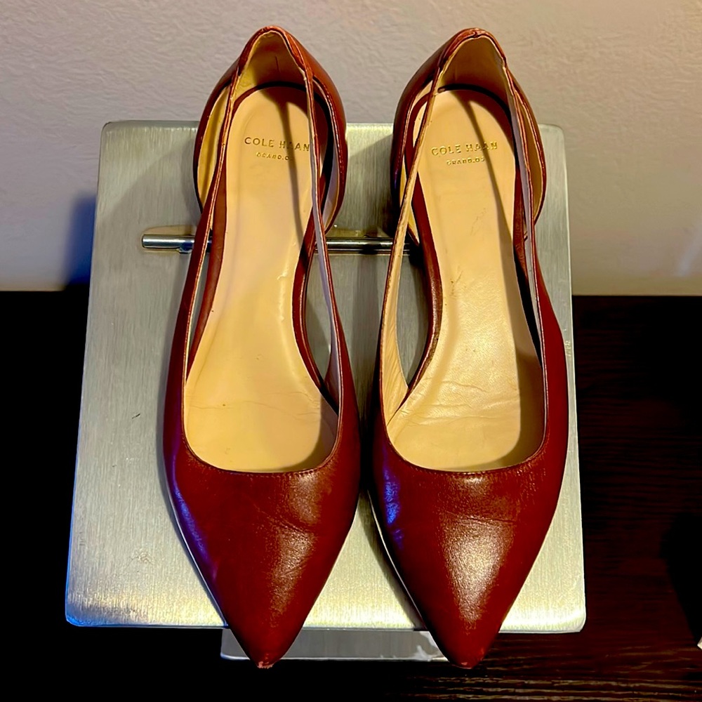 Genuine Cole Haan flats in good preowned condition. The right shoe is scuffed.